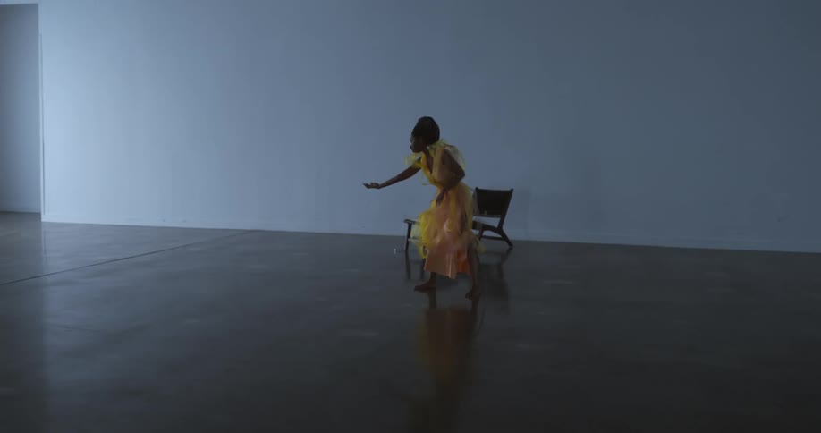 A woman is dancing in an empty room by herself