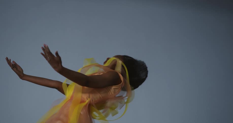 A woman is dancing by herself in a room