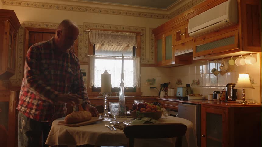 A man is cooking dinner in his kitchen