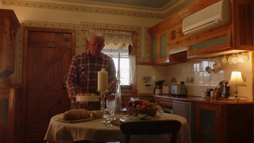 A man is in his kitchen and is cooking dinner