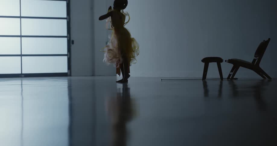 A woman dances indoors