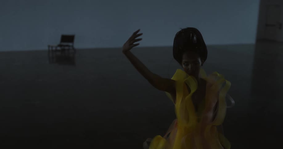 A woman performs a modern dance in an open studio