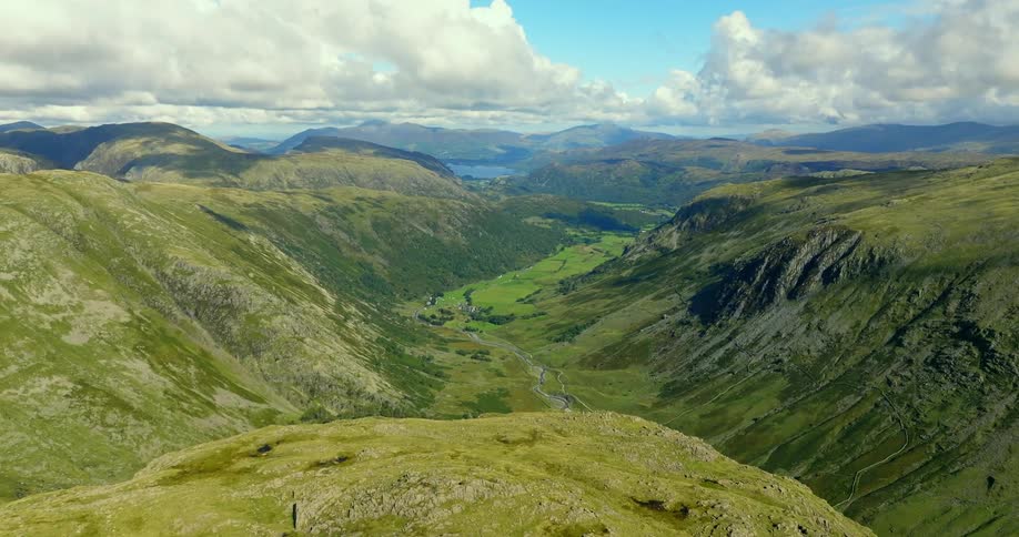 Aerial view of green valley between mountains