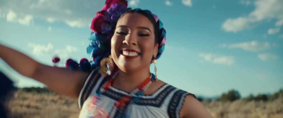 Happy woman performs a traditional latin american folk dance outdoors