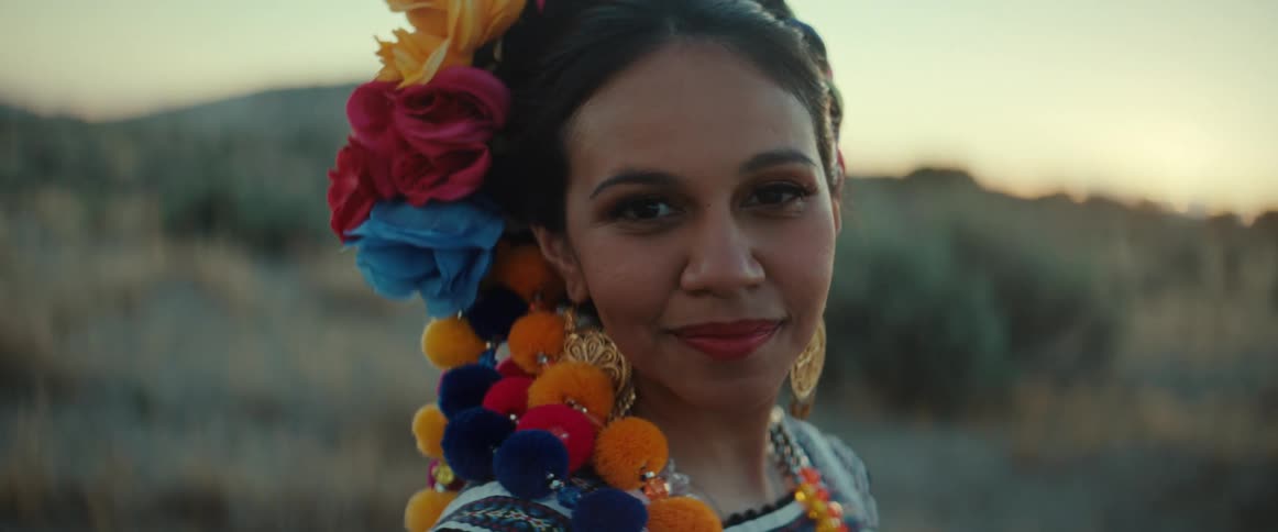 A woman wearing traditional Mexican headdress standing outdoors