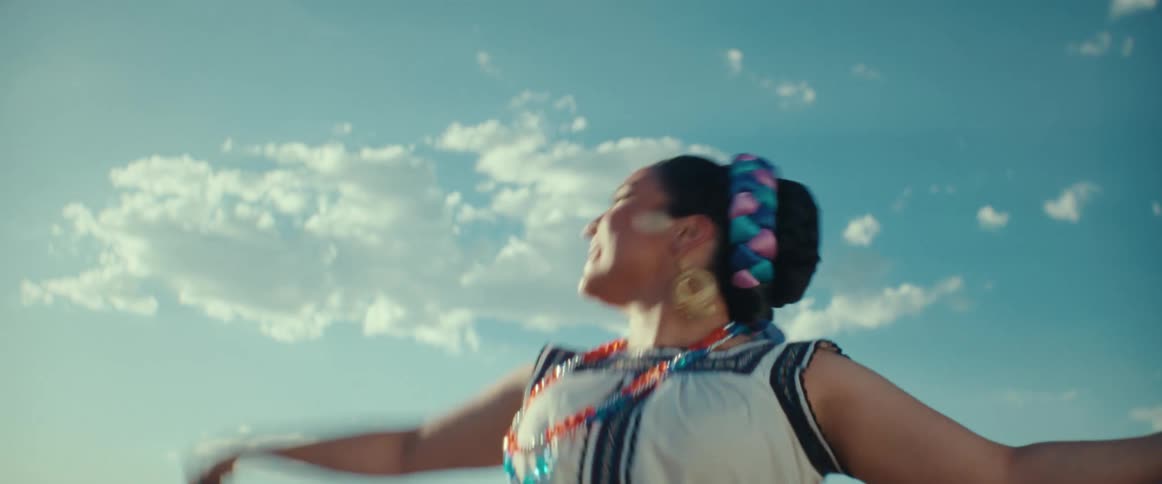 A woman is performing a traditional Mexican dance outside