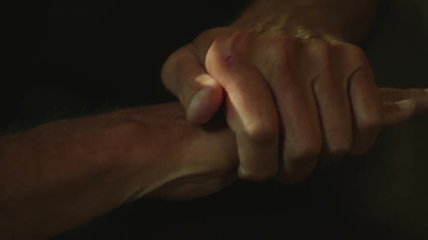 A person is clasping their hands