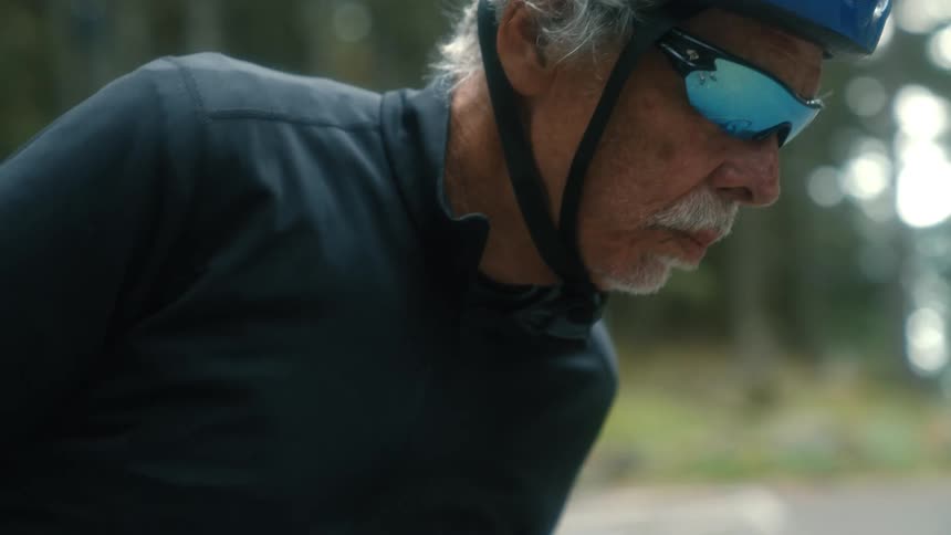 A man walking with a bicycle outdoors