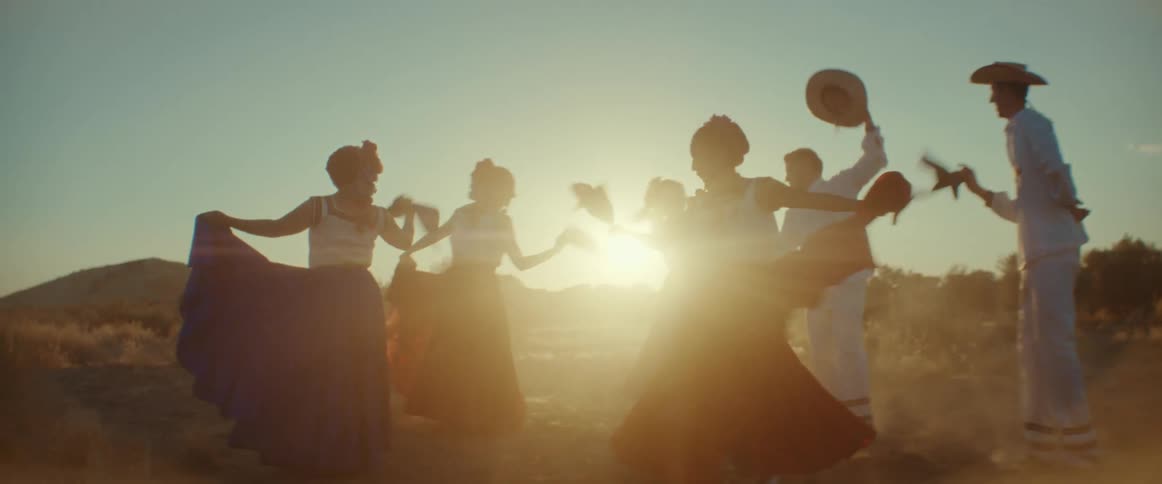 A group of people perform a traditional Mexican dance together