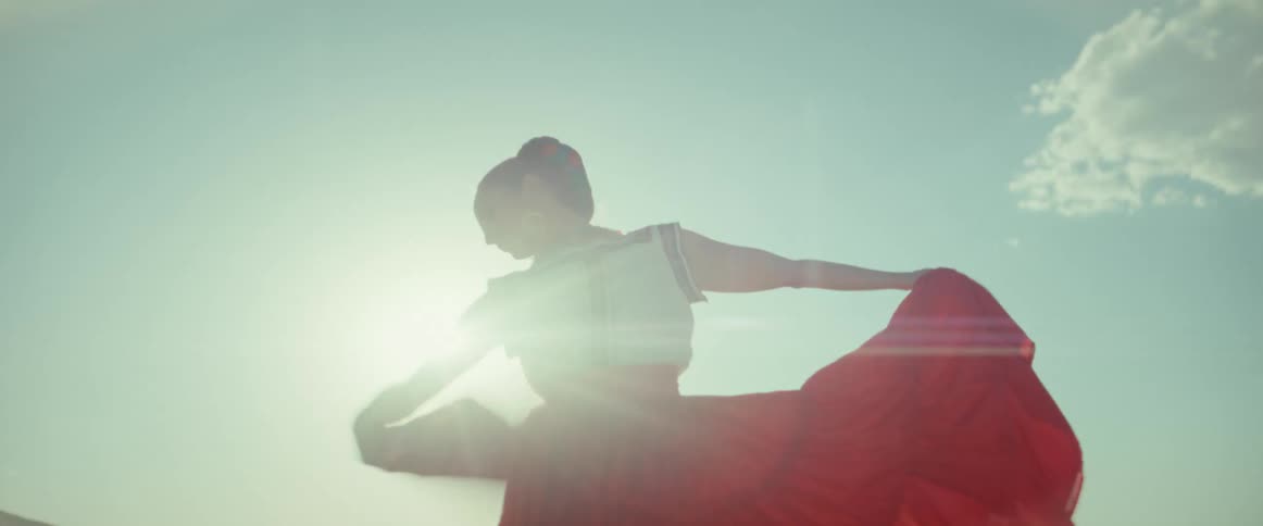 A woman is dancing on a sunny day