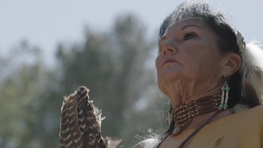 Proud native american woman walks slowly
