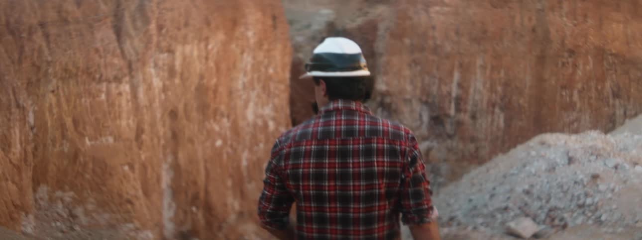 A man walks towards a cliff