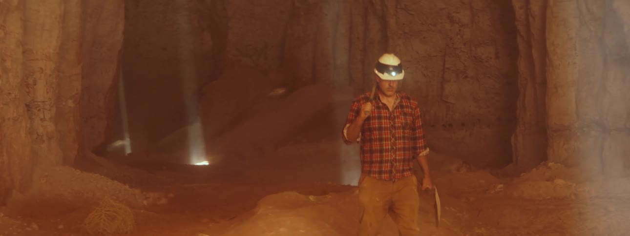 A miner walks through the cave