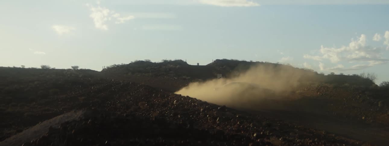 Smoke rises from a dirt mound