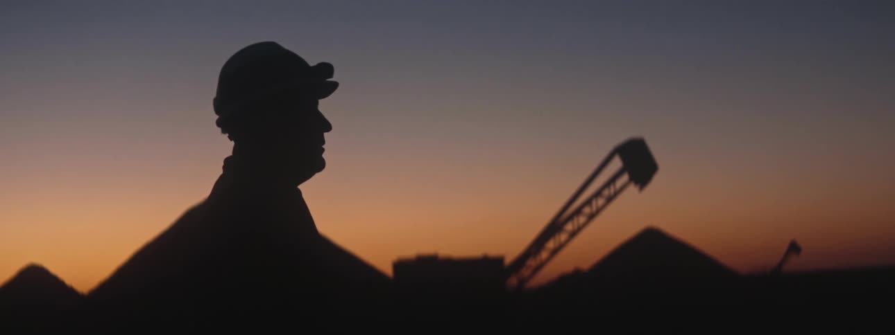 A man on a construction site at dusk