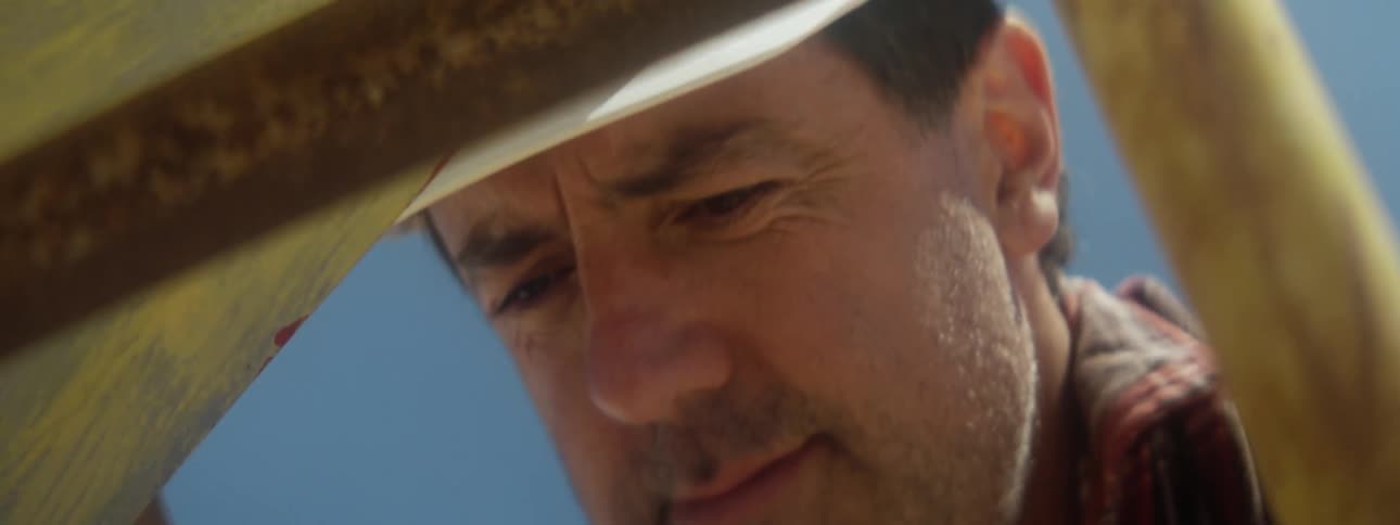 Male worker with headlamp on his hardhat thinks while working