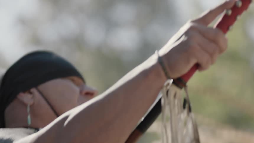 Man raising a spear at a celebration