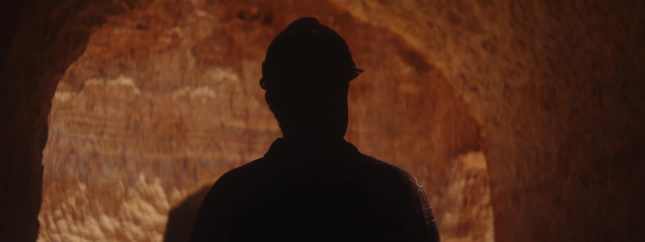 A miner is walking through the cave