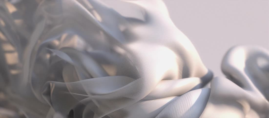 Light shines on a white textured substance that ripples and folds as it moves