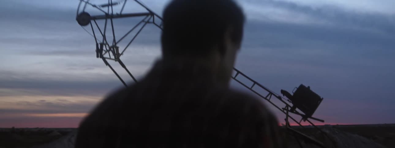 A man walking outdoors at sunrise