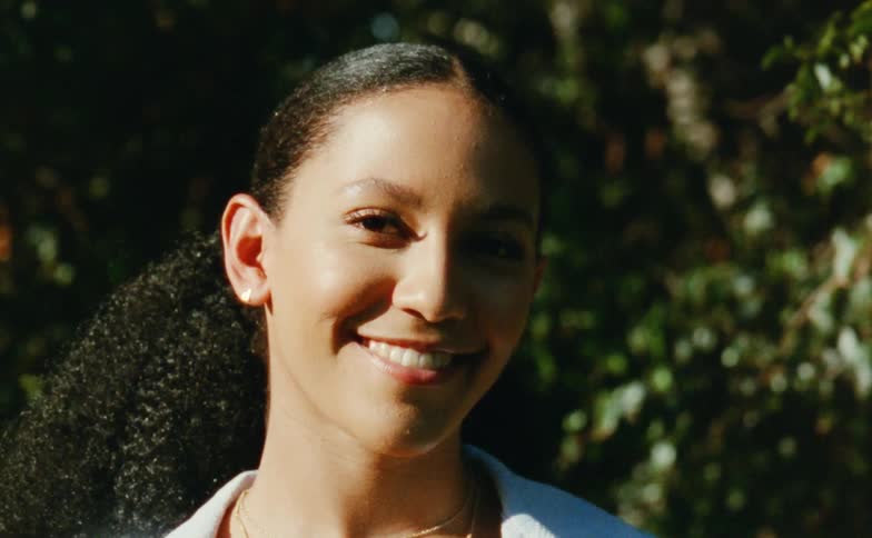 A woman is smiling outside