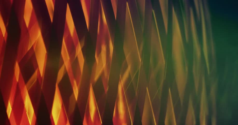 A diamond patterned lattice shade over a glowing light light spinning and turning