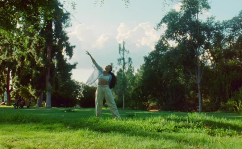 A woman is dancing by the forest