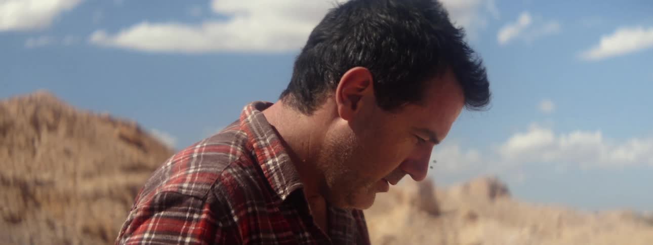 A man is walking by the mountains