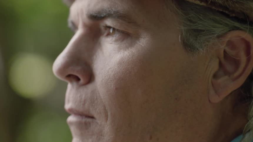 A man standing outside and staring in front of him