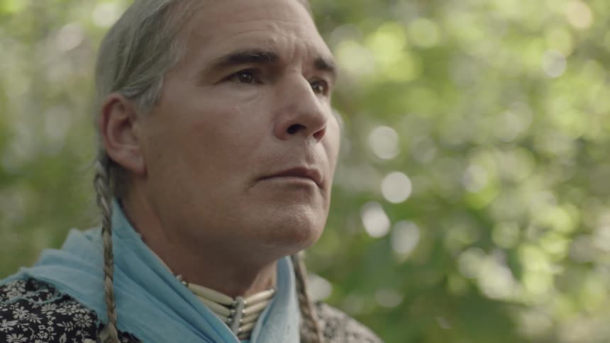 A native american man looks at his surroundings