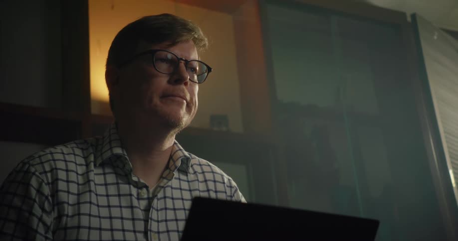 Man sits at home working on laptop