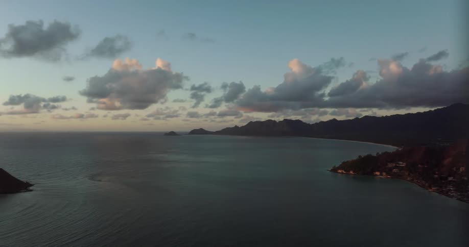 An aerial view of the ocean and houses on the shore