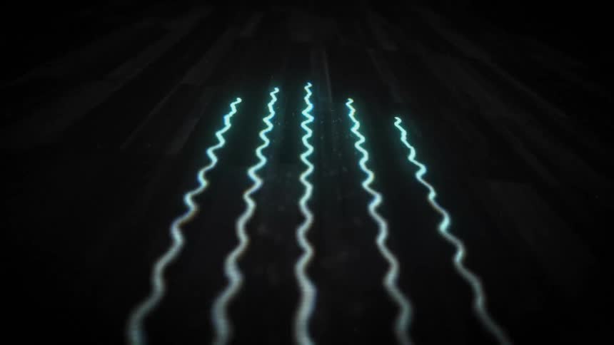 Light blue and green beams ripple as they streak across the darkness