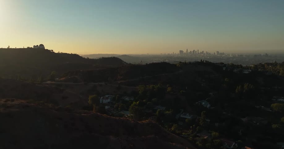 Downtown is visible in the distance from a canyon