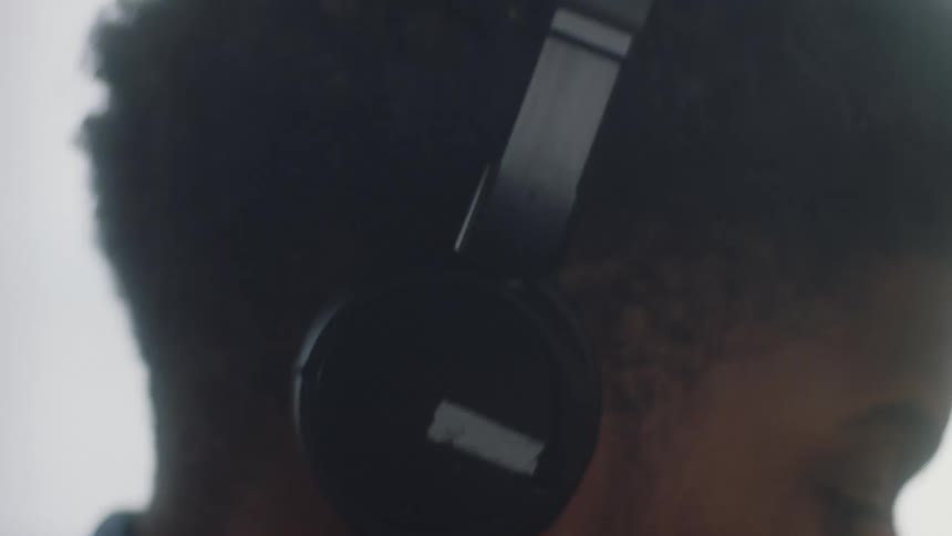Man puts on set of on ear headphones