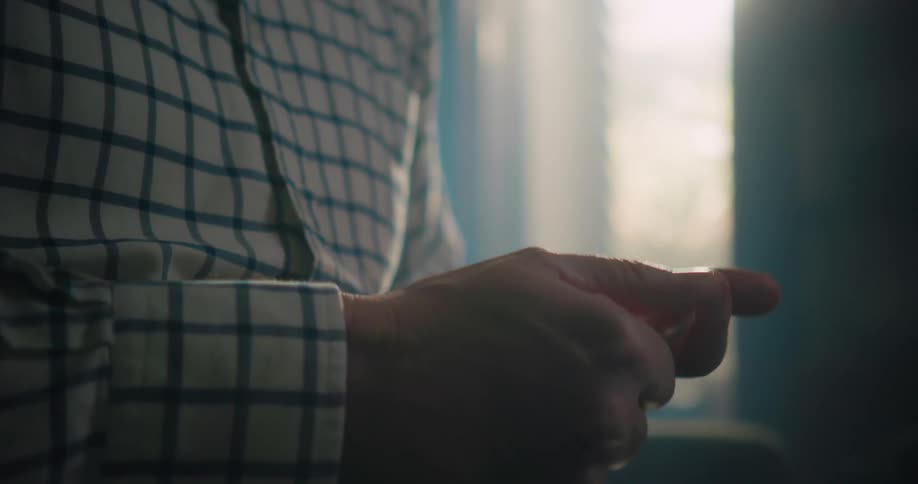 Close up of a mans hands as he counts with his fingers