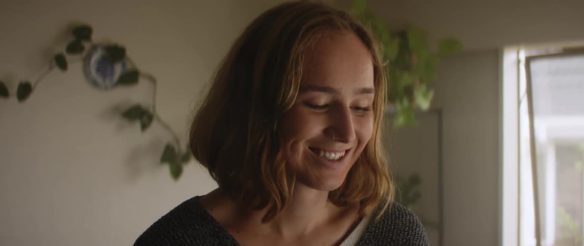 A woman is shaking her head as she smiles