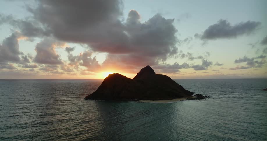 Two tiny mountainlike islands are shown in the middle of the vast ocean