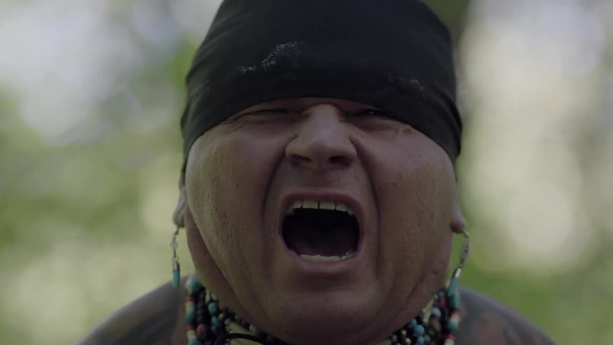 A native american man hollers