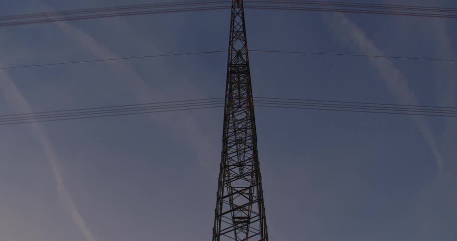 Sun turns sky red a short distance from electricity transmission tower