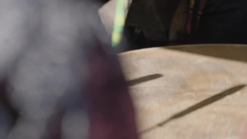 Close up of sticks hitting a drum
