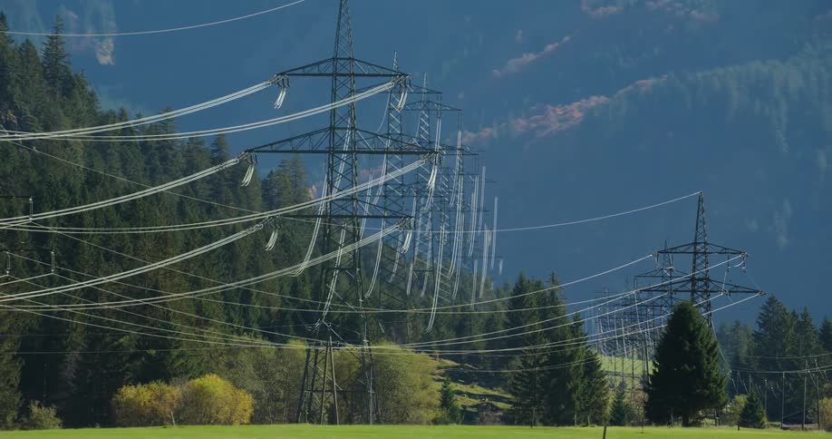 Large utility lines running through a forested area