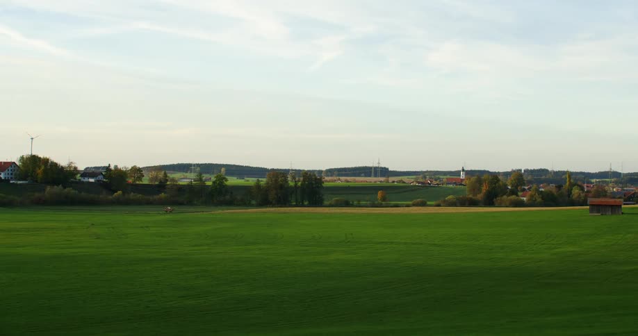 The view is of some grassland in the middle of the day time