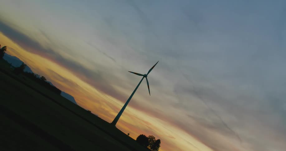 A wind turbine spinning in an open field