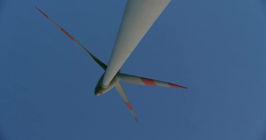 A rotating wind turbine on a clear day