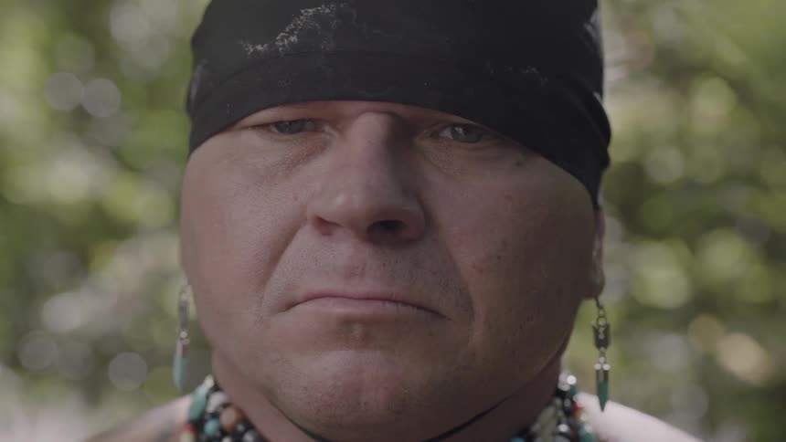 A man turns his head on a sunny day