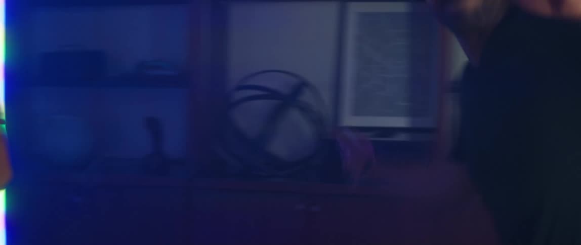A man and woman fling their arms around and laugh as they play a virtual reality game at home