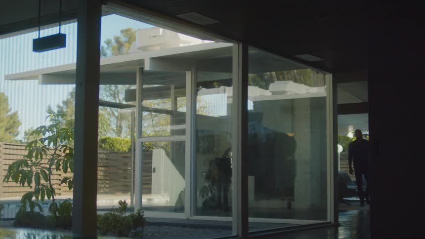 A person is walking around their house during spring