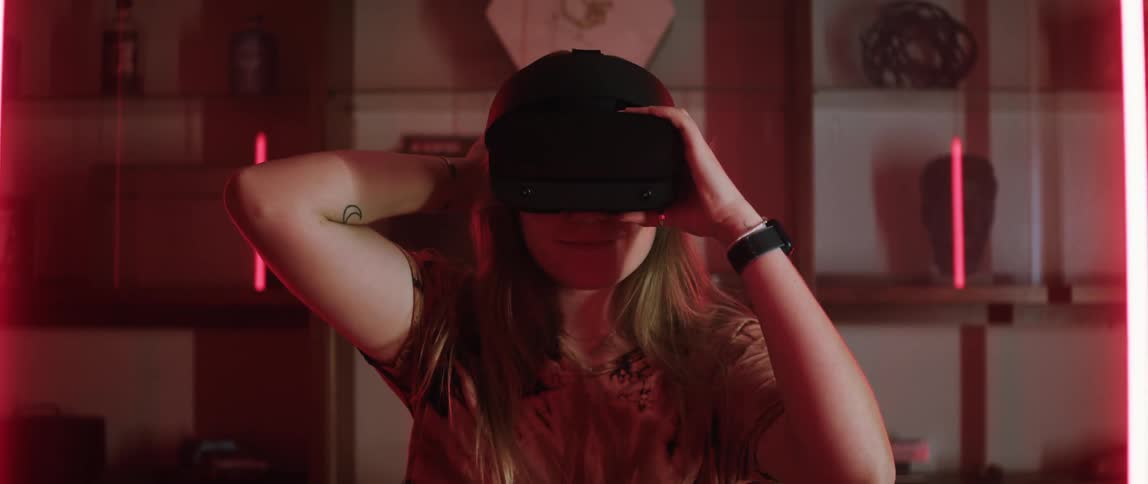 A teenage girl puts on virtual reality goggles