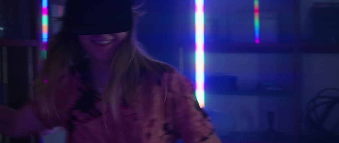Man and woman wearing vr headsets play a game of virtual tennis